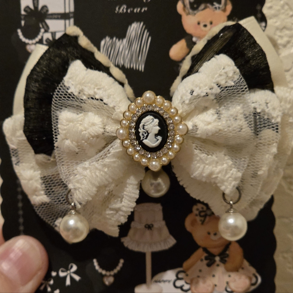 Elegant Black and White Bow with Cameo and Pearls